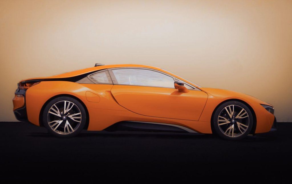 orange sports car glossy finish studio lighting